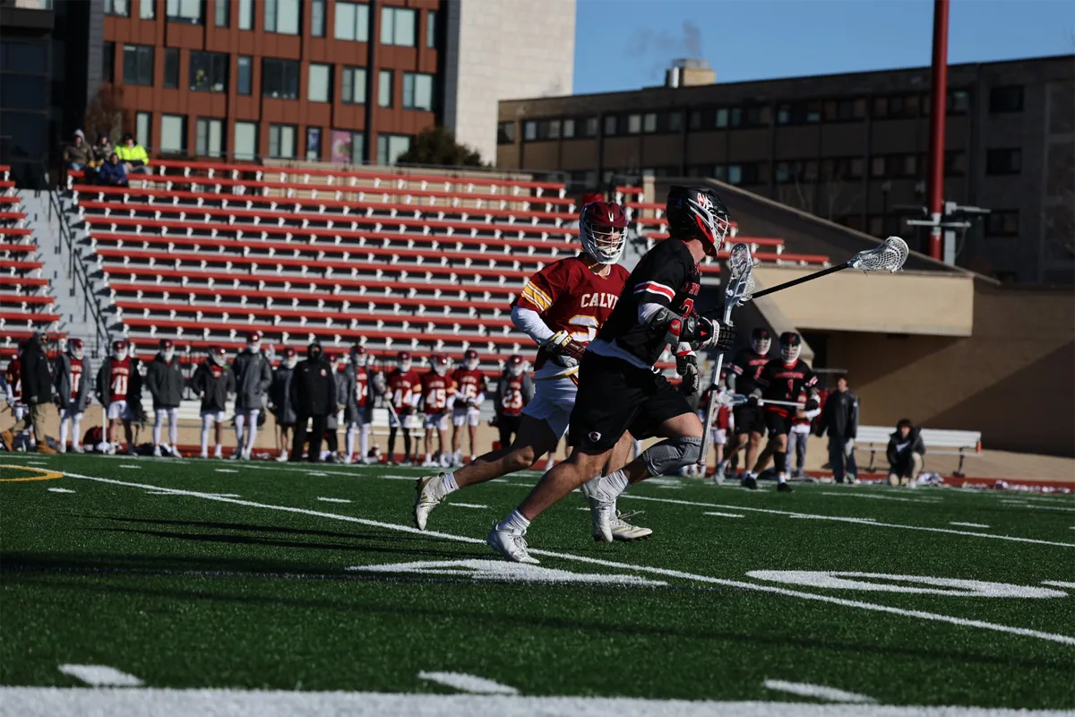 Carthage College Men's Lacrosse Player running with ball